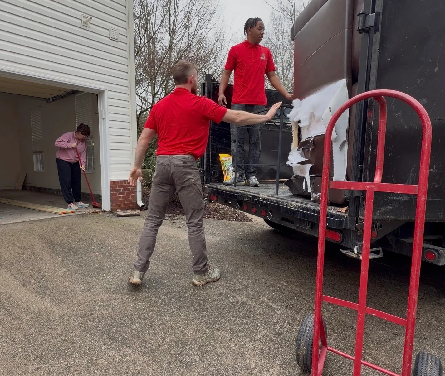 A removal crew loading a household item into a truck